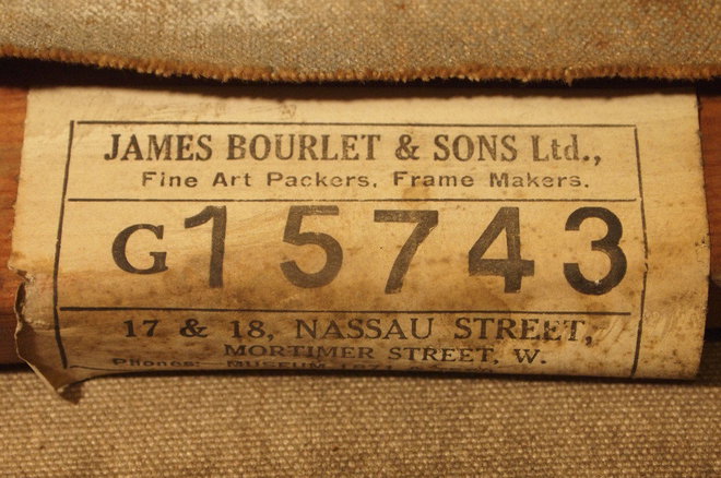 The stretcher maker's label on the reverse of the Annan oil painting 'Figure Knitting'